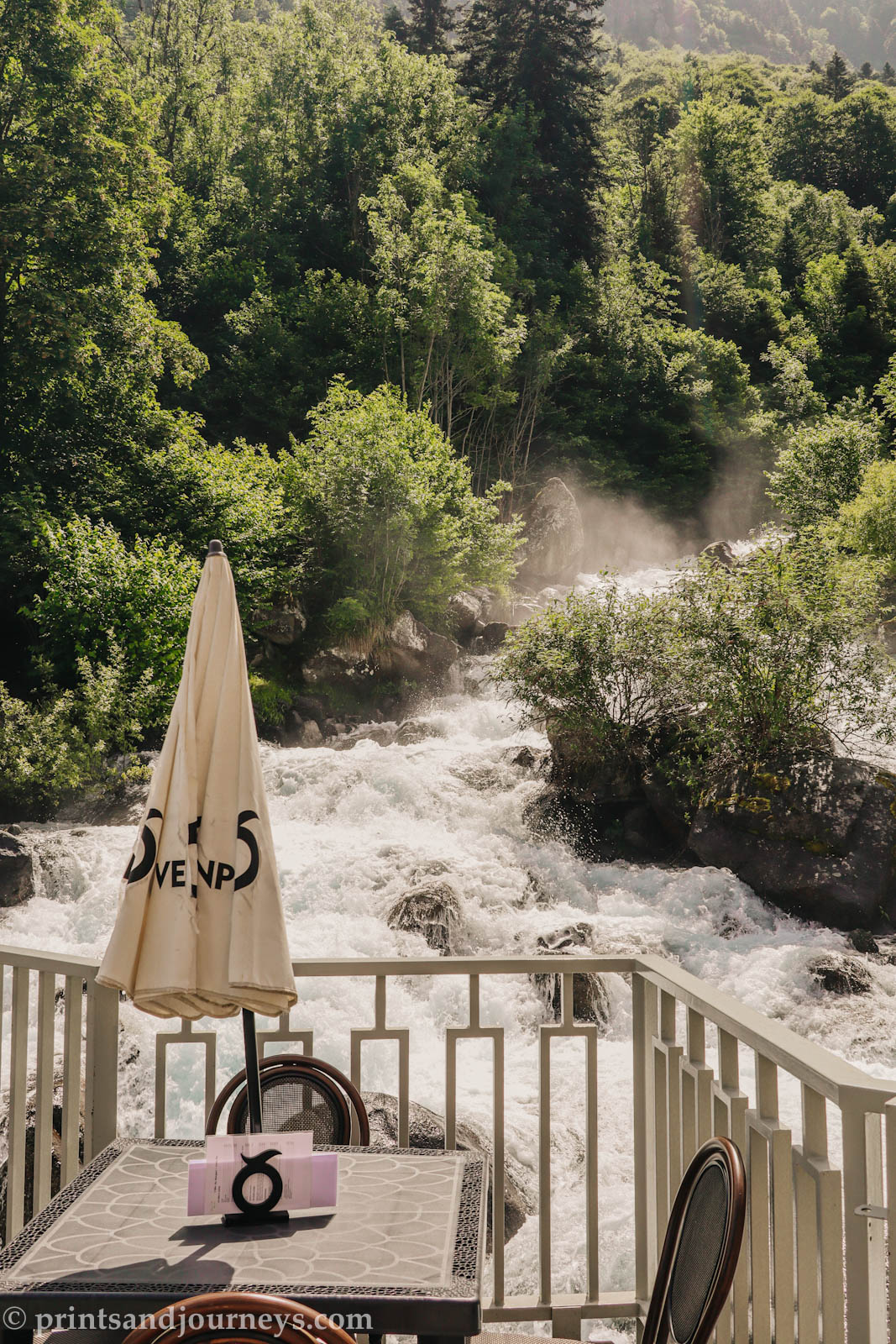 View from the terrace of L'Abri du Benques mountain refuge overlooking the Cascade du Lutour waterfall