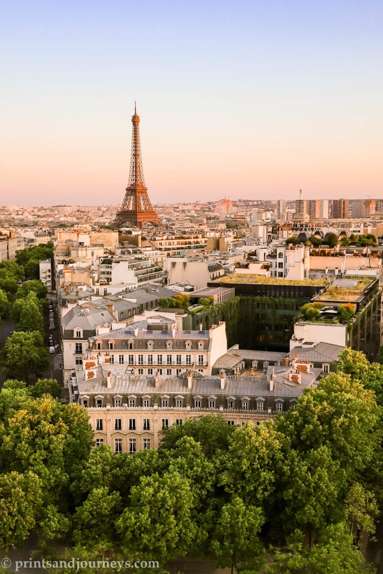 the eiffel tower and pink paris skyline at sunset taken from the arc du triumpe