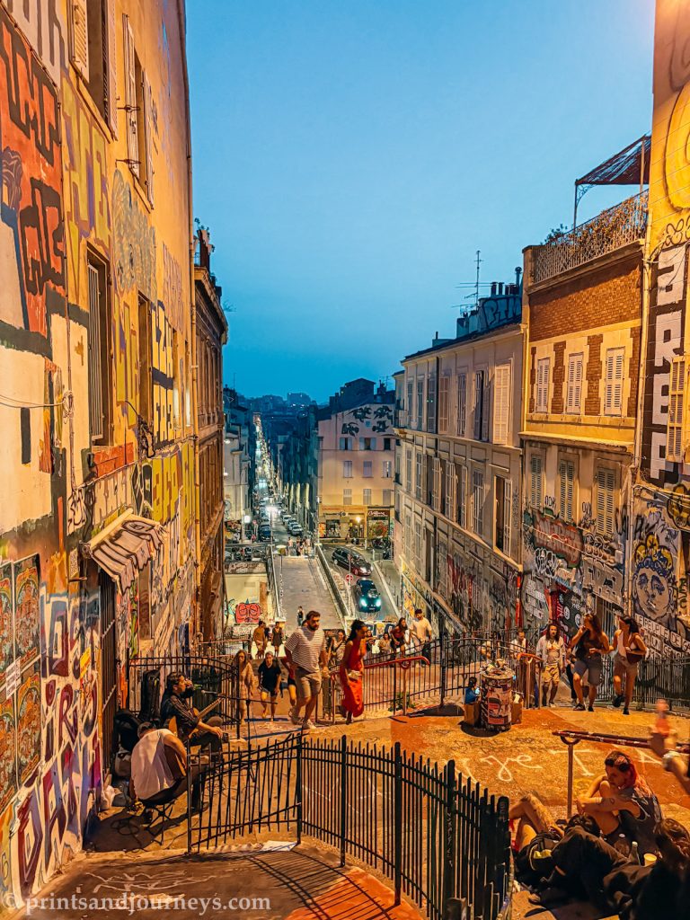 People sitting, smoking and busking on the escaliers du cours julien in marseille early evening