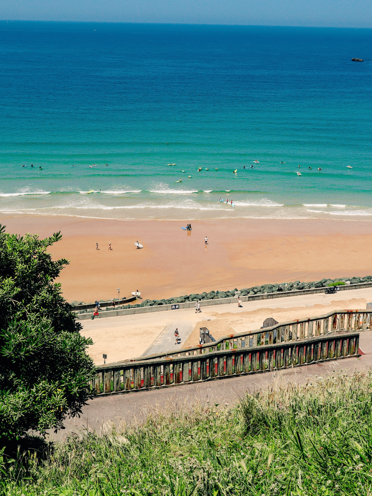 cote des basques beach from above with surfers and beachgoers